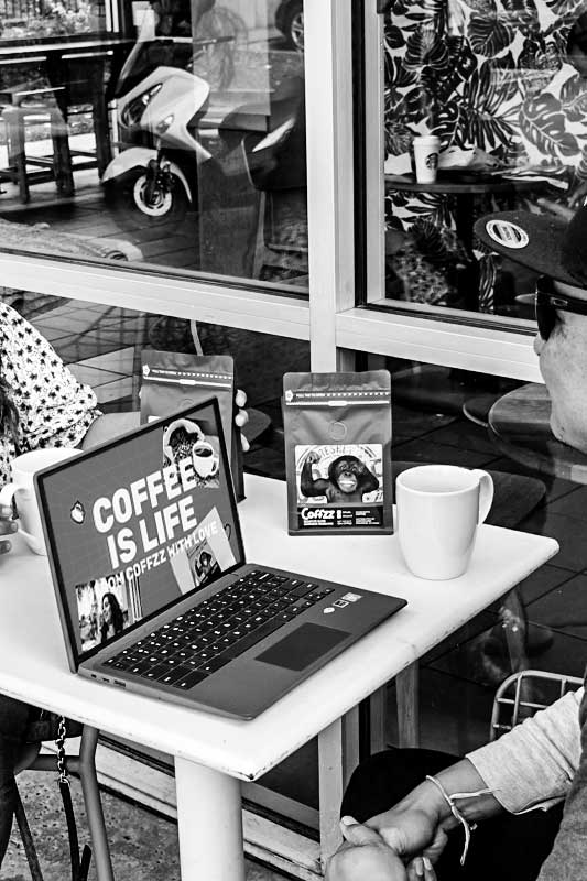 man drinking coffee with computer